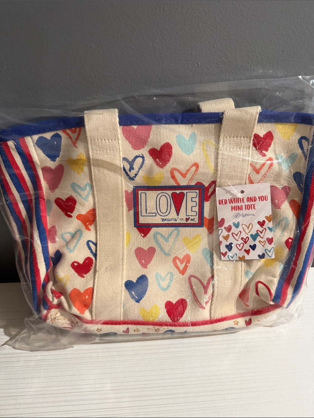 Brighton, red white & you mini tote. Sealed in bag, but has a smudge as pictured